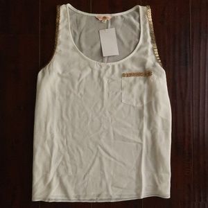 White top with gold trip